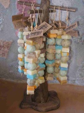 Soap Collar Display: A rustic rack hung with strings of small soaps.